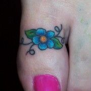 a small flower tattoo on someone's left foot, with the word toe ring tattoos - bing images