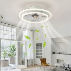 a living room with white furniture and green leaves painted on the wall behind the ceiling