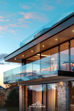 a modern house with glass balconies overlooking the ocean