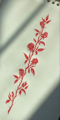 a piece of paper with red flowers on it