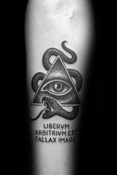 a black and white tattoo with an all seeing eye in the center, surrounded by snakes