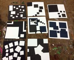 several pieces of art that are laying on the ground with paint all over them, including squares and rectangles