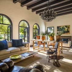 a living room filled with furniture and lots of windows