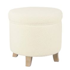 a white ottoman with wooden legs and a round footstool on the bottom side