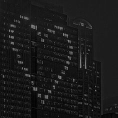 black and white photograph of skyscrapers at night