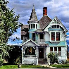 an old victorian style house with blue trim and two story windows on the second floor