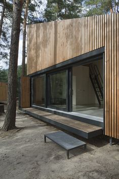 a wooden structure with glass windows and stairs