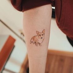 a small dog tattoo on the leg