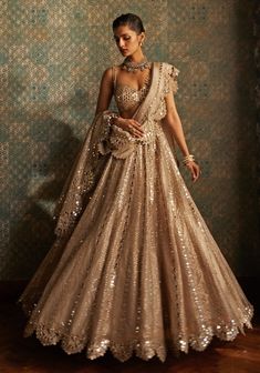 Buy Beige Gold Sequins Lehenga With Embroidered Blouse by Vvani by Vani Vats at Fabilicious Fashion! Shop made-to-measure Indian wedding wear and jewellery with fast shipping to USA, UK, and Canada. Formal Lehenga, Sangeet Outfit Bridal, India Outfits, Mirror Blouse, Indian Outfits Modern, Punjabi Girl, Sequins Lehenga, Vani Vats, Sequin Lehenga