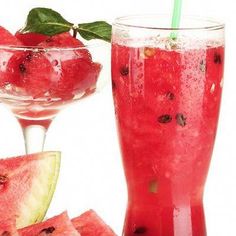 watermelon juice in a tall glass next to slices of watermelon