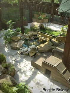 a small garden with rocks and water in it