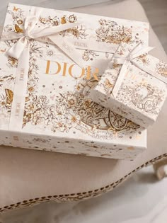 the dior gift box is wrapped in white and gold foil