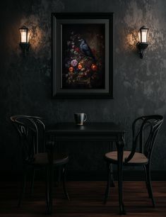 two chairs and a table in a dark room with a painting on the wall above it