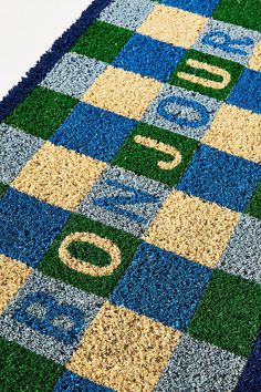 an area rug with letters and numbers on it in blue, green, yellow and white colors