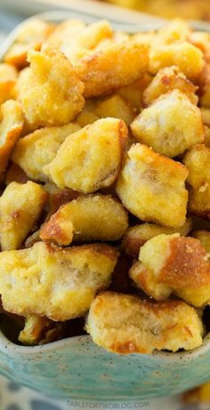 a bowl filled with fried food sitting on top of a table