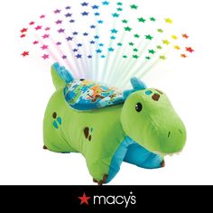 a green stuffed animal with stars on it's back