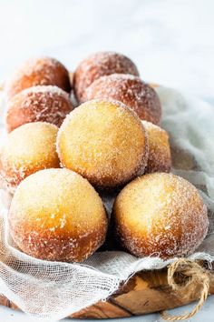 a bunch of doughnuts sitting on top of a cloth