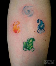 four different colored tattoos on someone's left arm, including one with leaves and an umbrella