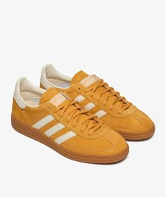 Founded in Germany, adidas has been at the forefront of sportswear since 1949, blending performance innovation with a streetwise aesthetic. Known for championing creativity and individuality, adidas invites you to express yourself through timeless classics and contemporary style.Step into the season with the adidas Handball Spezial, your new go-to for Fall/Winter 2024. This iconic model, revered for its retro style and enduring comfort, effortlessly captures adidas's storied heritage. These clas Adidas Handball Spezial Yellow, Adidas Spezial Yellow, Adolf Dassler, Women's Handball, Retro Trainers, Adidas Handball Spezial, Yellow Adidas, Adidas Handball, Global Icon