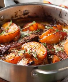 a pot filled with meat and vegetables on top of a table