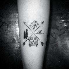 a black and white photo of a person's leg with an arrow tattoo on it