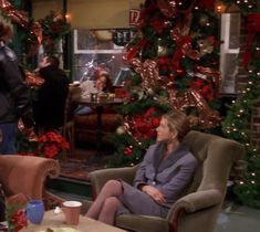 two women sitting in chairs talking to each other on the set of tv show friends