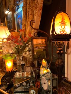 a table topped with lots of different types of lamps and pictures next to each other