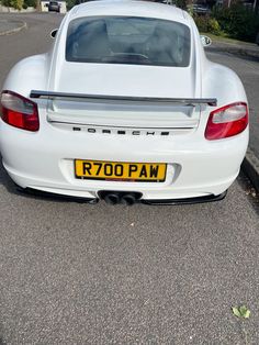 the back end of a white porsche sports car