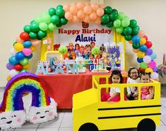 two children are sitting in a school bus decorated with balloons