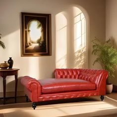 a red leather couch sitting in front of a window next to a potted plant