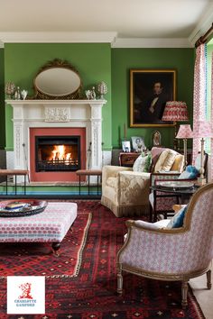 a living room filled with furniture and a fire place next to a painting on the wall