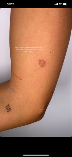 a woman's arm with a small tattoo on the left side of her leg