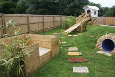 an outdoor play area in the backyard with stairs and steps leading up to a slide