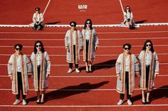 several women in white outfits standing on a track