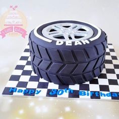 a birthday cake made to look like a tire on top of a checkered table