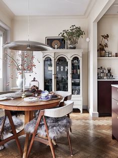 a dining room table with two chairs around it