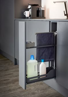 an open cabinet with two bottles and towels