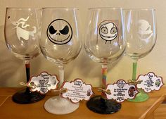 three wine glasses with different designs on them