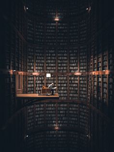 a room filled with lots of books next to a lamp on top of a table