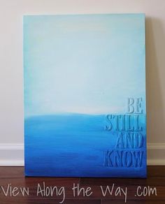 a painting with the words be still and know on it in blue, white and grey