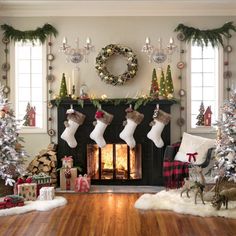 a living room decorated for christmas with stockings on the fireplace