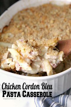 chicken cordon blue pasta casserole in a white dish with a wooden spoon