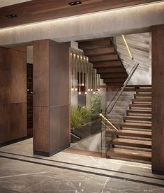 an empty lobby with stairs leading up to the second floor and plants on the other side