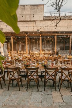 an outdoor dining area with wooden tables and chairs