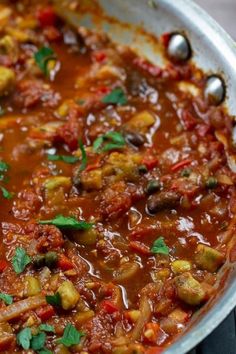 a pan filled with lots of food on top of a stove