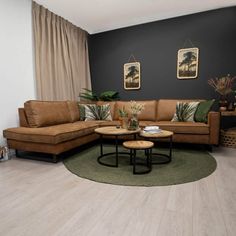 a living room with two brown couches and a round coffee table in the middle