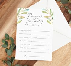 a card with the words prayer for baby written on it next to some flowers and greenery