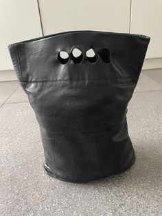 Super cool black leather bag by Quentin Mackay.  At the cutting edge of contemporary design this bag has round cut outs for your fingers to carry it. In great used condition. Measures 38 cm length and 27 cm width. Leather Accessory, 2024 Bags, Edgy Black Bag With Hardware, Punk Bag, Designer Bag, Black Leather Bag, Leather Bags, Bag Design, Rugged Black Leather Bag