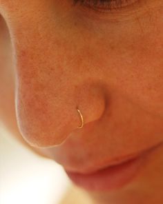 a close up of a person with a nose piercing