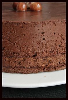 a chocolate cake sitting on top of a white plate